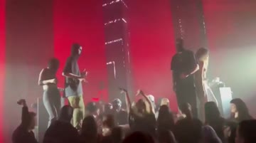 random girl climbs the dj's stand, gets topless and dances for the crowd. wish there was a clearer video tho