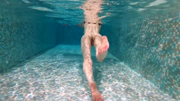 nude swimming after pulling off her clothes