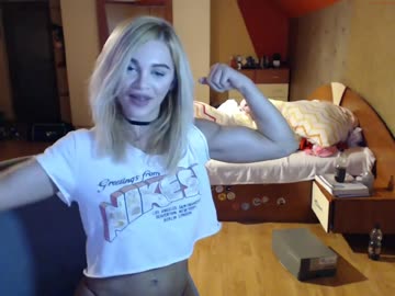 blonde girl shows her biceps and fit body