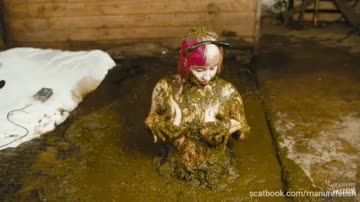 young busty girl play with herself in pool of cow shit.