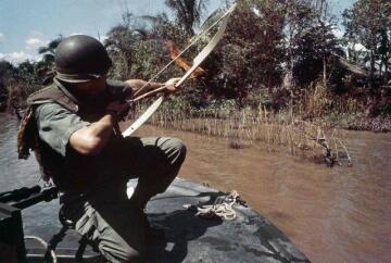 lieutenant commander donald d. sheppard, of coronado, ca, aims a flaming arrow at a bamboo hut concealing a fortified viet cong bunker on the banks of the bassac river, vietnam, december 8, 1967. [640x431]