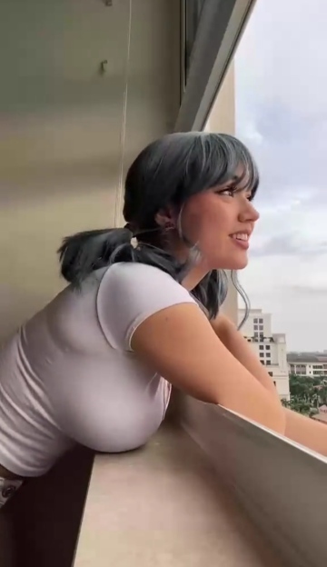 busty and natural looking out through the window