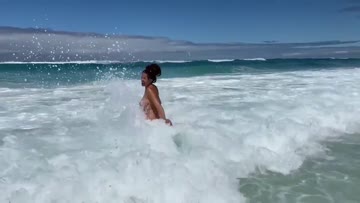 having fun trying to get into the ocean