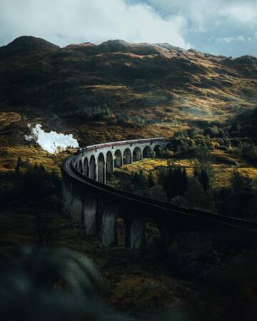 the jacobite, a steam locomotive-hauled train on the glenfinnan viaduct in the scottish highlands, inverness-shire, scotland.