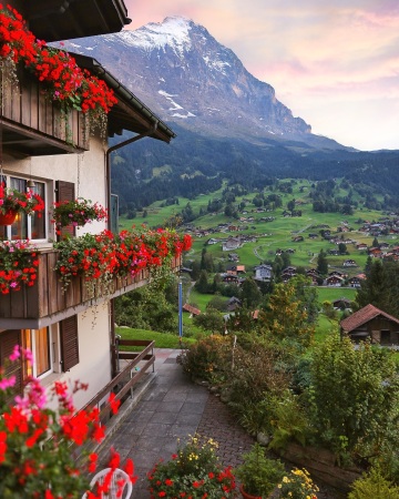 a chalet overlooking the rolling green hills of grindelwald, canton of bern, switzerland.