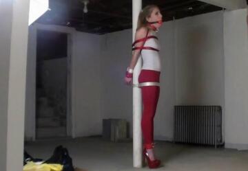 tied to a pole. and gagged