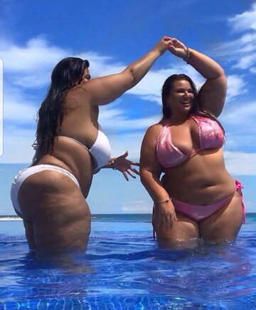 two big bikini babes having fun in the pool