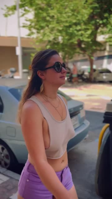 braless in top too small to cover tits walking in the street.
