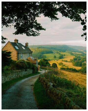 cottage overlooking the rolling green hills and fields of peak district, derbyshire, england.
