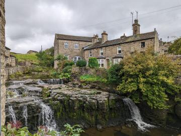 stone-built houses and waterfalls entering hawes, yorkshire. [oc}.