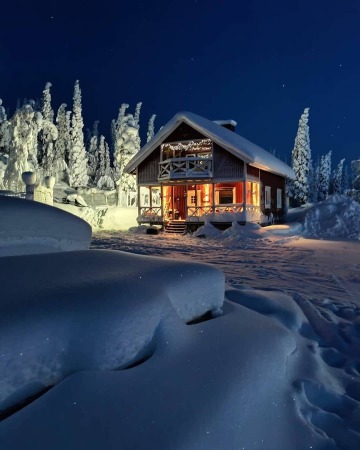 arctic night skies over a winter cabin, avvakko in norrbotten county, northern sweden.