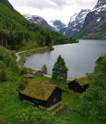 turf roof cabins on the shores of lovatnet lake, stryn, vestland county, western norway.