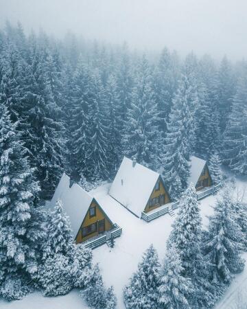 a-frame cabins in the winter forest, thuringia, central germany.