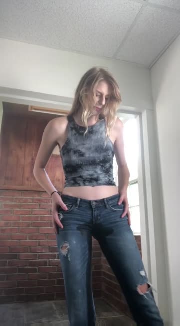 blonde girl wets her jeans for fun