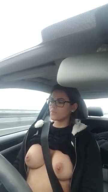 beautiful girl playing with her tits while driving