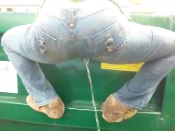 wetting her jeans while climbing on a dumpster
