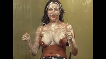 woman can't stop giggling as cake after cake is destroyed all over her