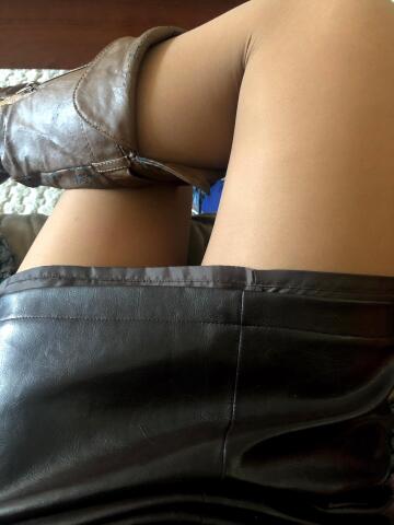 just a day at the office - leather skirt, boots, and suntan hose.