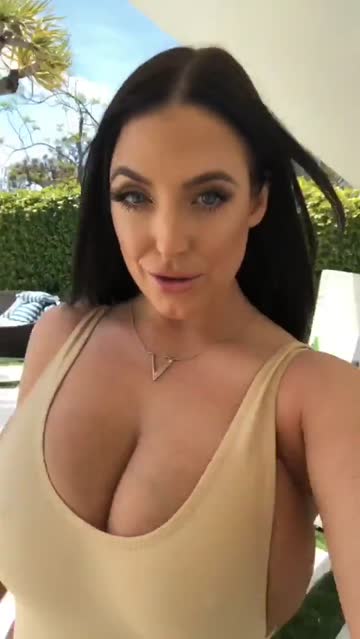angela walks for us again. her top can hardly hold her breasts in.