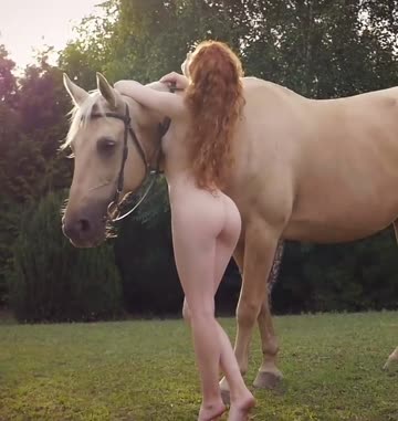just heidi romanova standing next to a horse