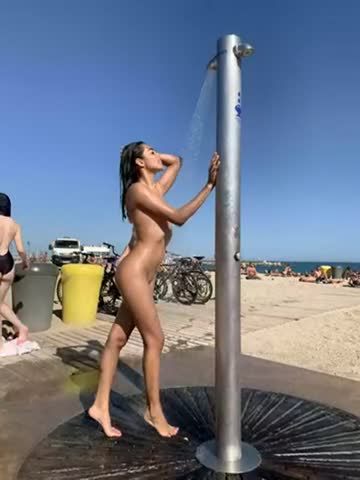 rinsing herself at a public beach