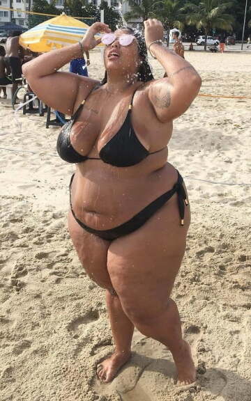 confident bikini babe cooling down on the beach