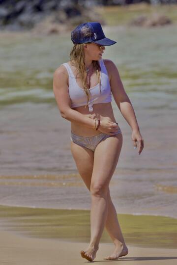hilary duff teasing in a wet, white bikini top at the beach