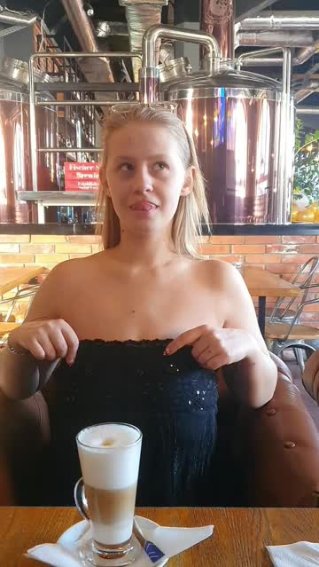 in the foreground, me and my big boobs and in the background, the vats for making beer.